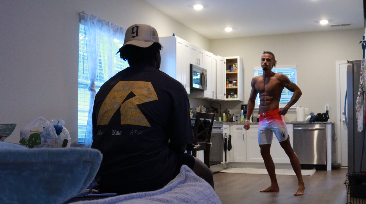 Marcellus Simmons coaching a client through a posing practice